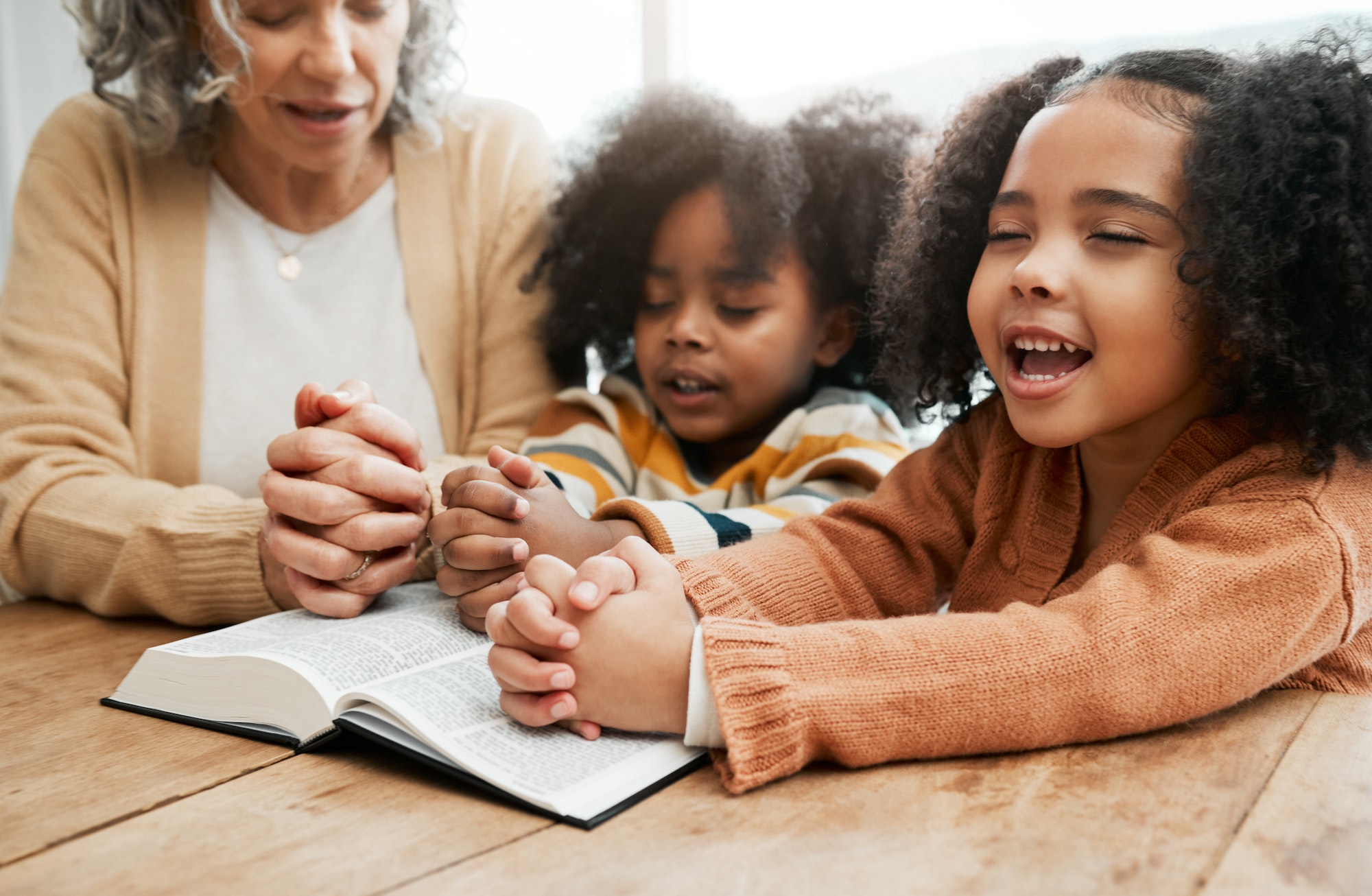 Bible, worship or grandmother praying with kids or siblings for prayer, support or hope in Christia